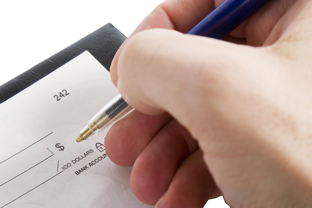 Someone signing a cheque